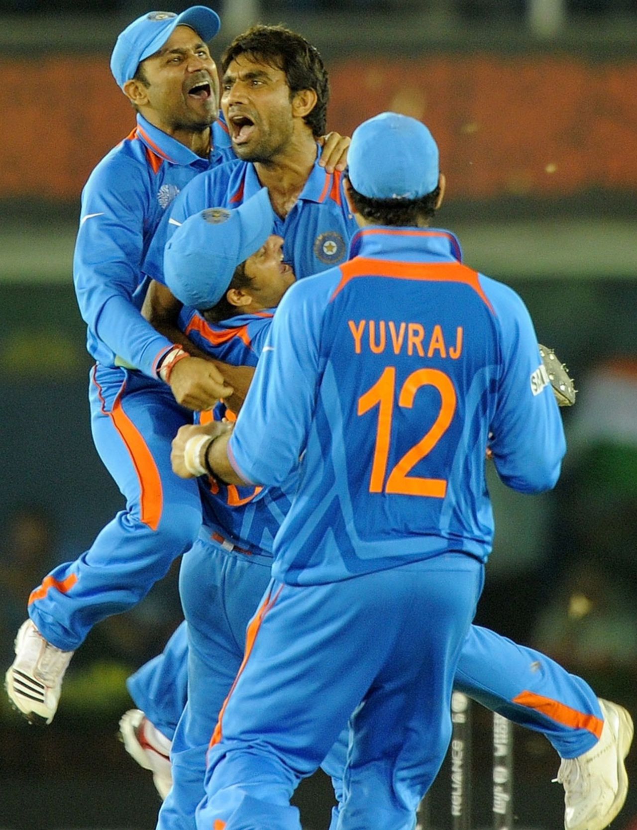Yuvraj Singh, Virender Sehwag and Suresh Raina rush to celebrate the fall of a wicket with Munaf Patel, India v Pakistan, 2nd semi-final, World Cup 2011, Mohali, March 30, 2011