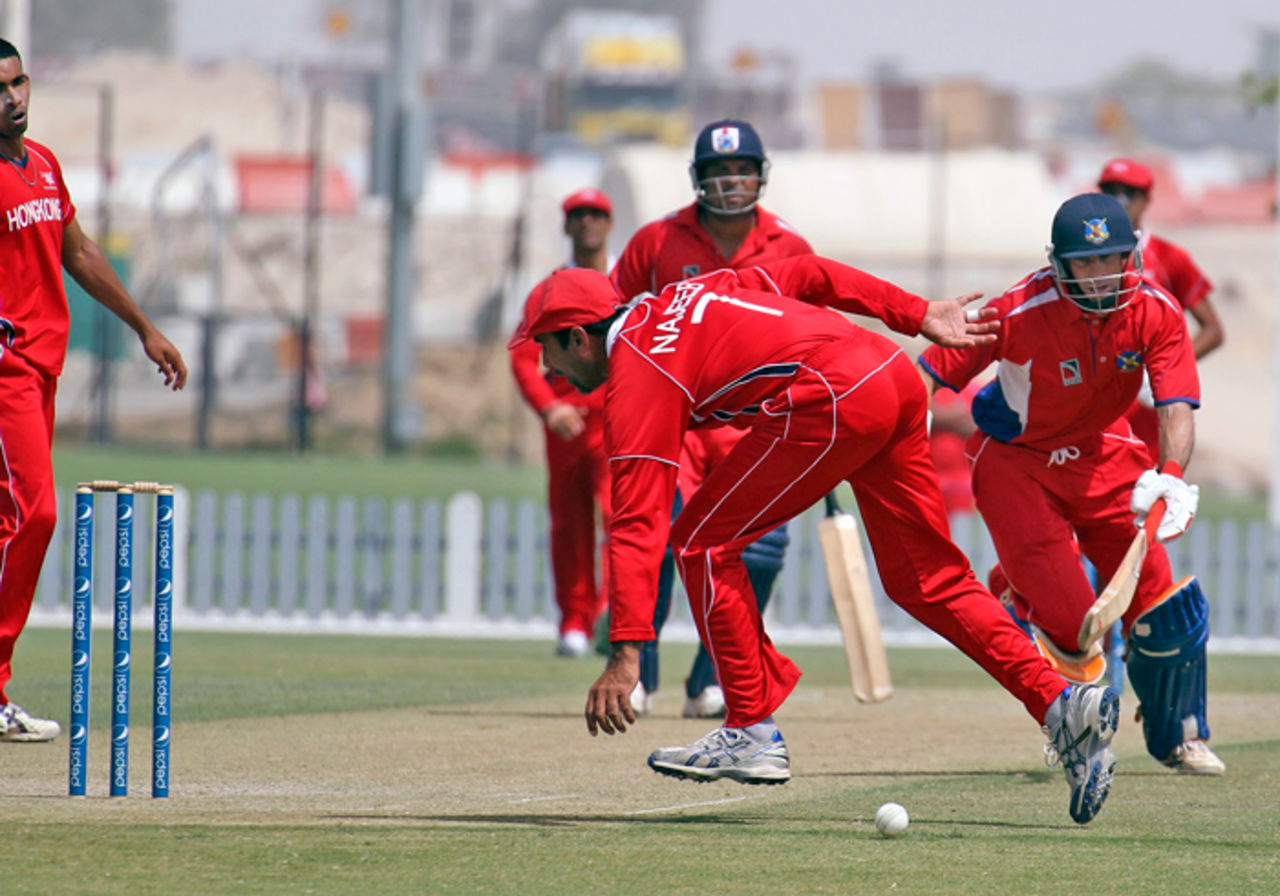 Bermuda's David Hemp survives an early scare when Hong Kong's Najeeb Amar fails to complete the run-out opportunity during their ICC World Cricket League Division 2 match at the ICC Global Cricket Academy in Dubai on 9th April 2011