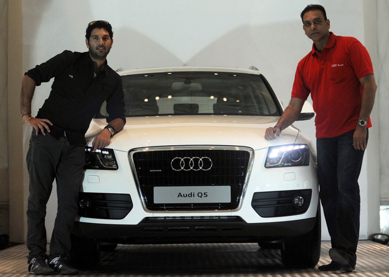 Yuvraj Singh and Ravi Shastri pose in front of a car at a function, Mumbai, April 14, 2011