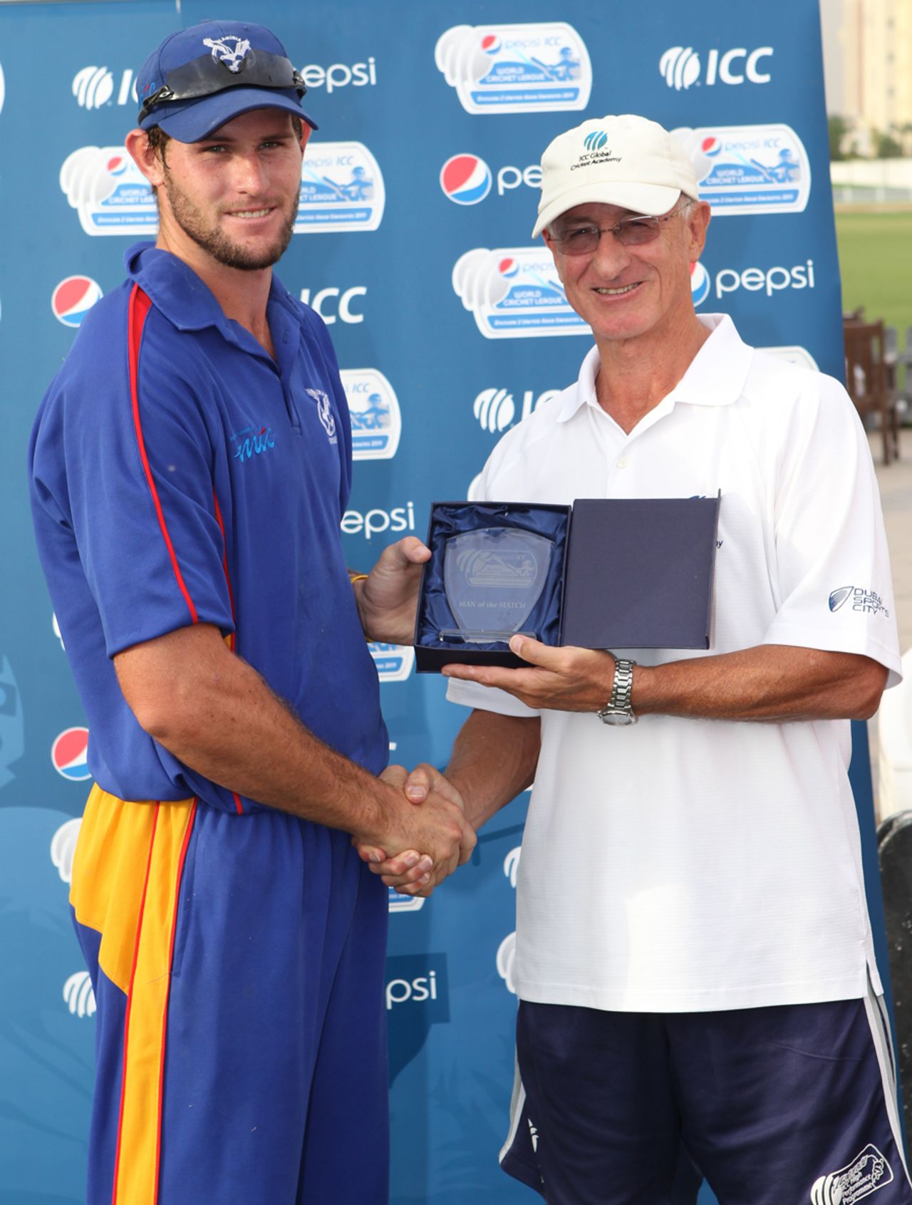 Louis Klazinga receives his Man of the Match Award from former New Zealand international Dayle Hadlee after taking 5-50 against Hong Kong at the ICC WCL2 in Dubai on 14th April 2011