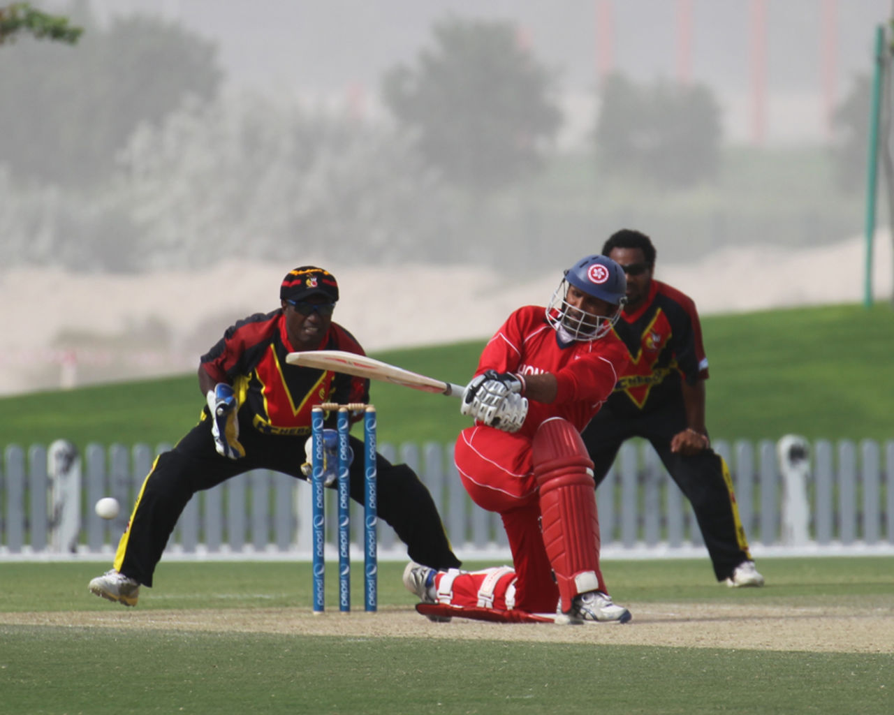 Najeeb Amar sweeps against PNG in the 3rd/4th Play-off match at the ICC WCL2 in Dubai on 15th April 2011
