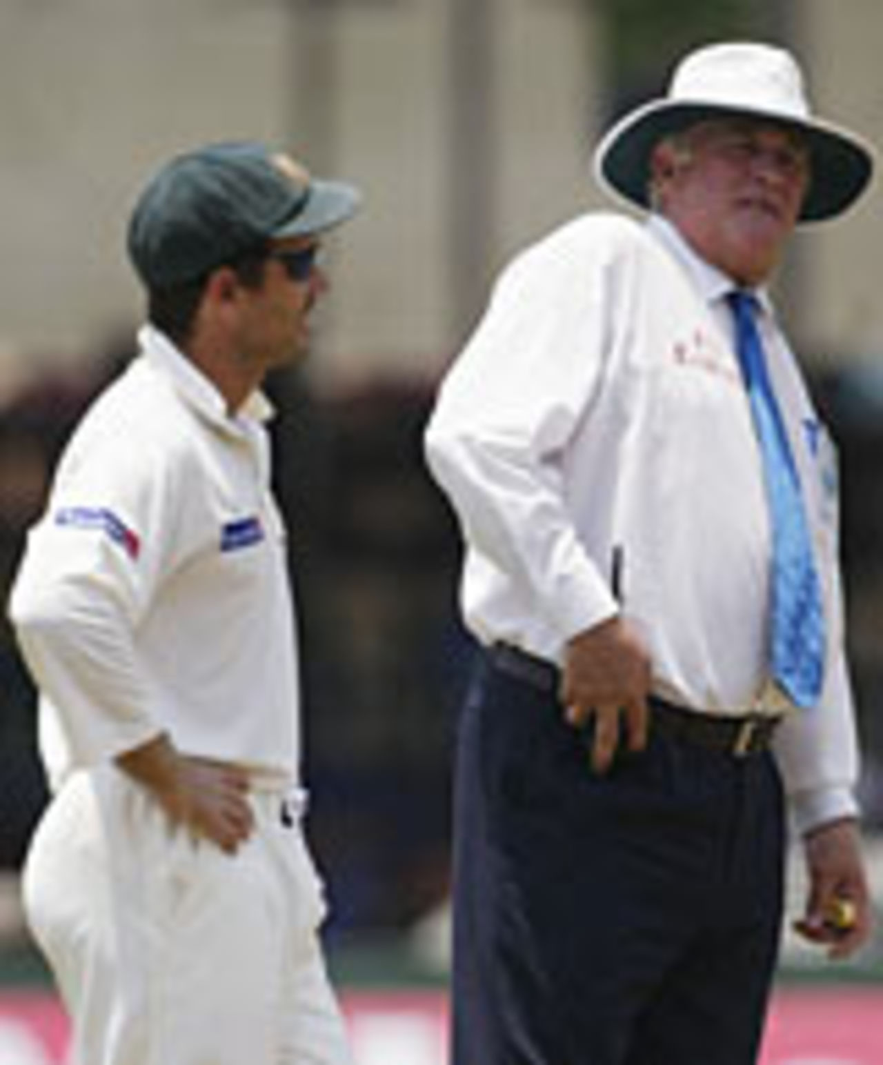 Justin Langer of Australia and umpire David Orchard discuss an incident that lead to the third umpire being called to investigate an appeal for hit wicket against Hashan Tillakaratne of Sri Lanka it was later revealed that the wicket had been broken by Justin Langer , Sri Lanka v Australia, 3rd Test, Colombo, 3rd day, March 26, 2004