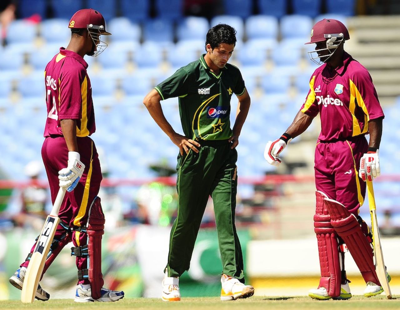 Junaid Khan walks past the West Indian openers Devon Smith and Lendl Simmons, West Indies v Pakistan, 2nd ODI, Gros Islet, April 25, 2011