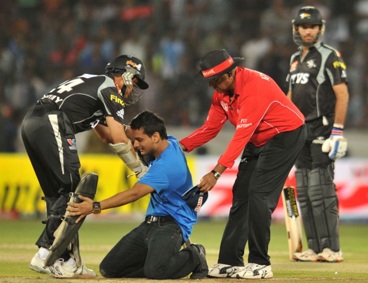 An emotional fan runs into the field to touch Sourav Ganguly's feet during his comeback innings, Deccan Chargers v Pune Warriors, IPL 2011, Hyderabad, April 10, 2011