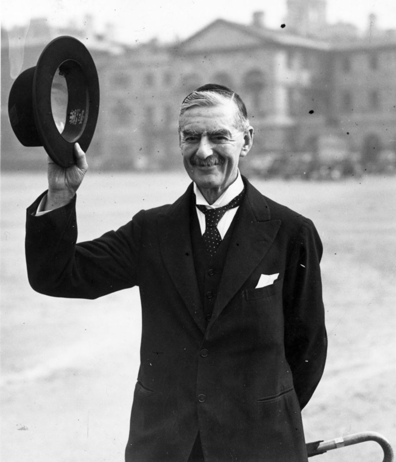 Neville Chamberlain, the British prime minister, raises his hat, March 1, 1940