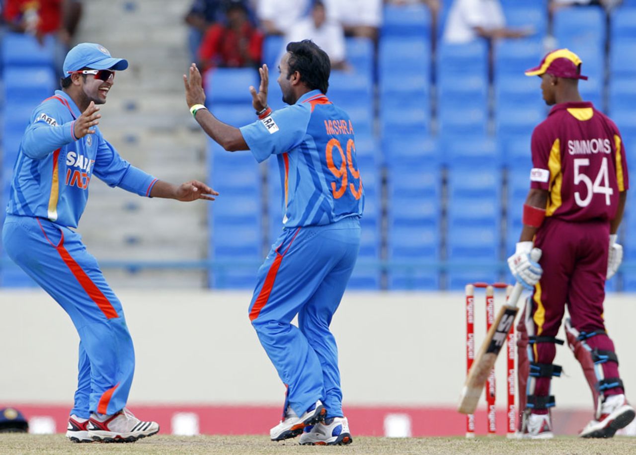 Amit Mishra and Suresh Raina celebrate the dismissal of Lendl Simmons, West Indies v India, 3rd ODI, Antigua, June 11, 2011