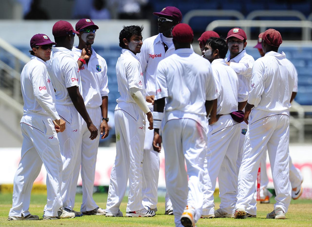 Devendra Bishoo is congratulated after striking with his first ball of the Test, West Indies v India, 1st day, 1st Test, Kingston, June 20, 2011