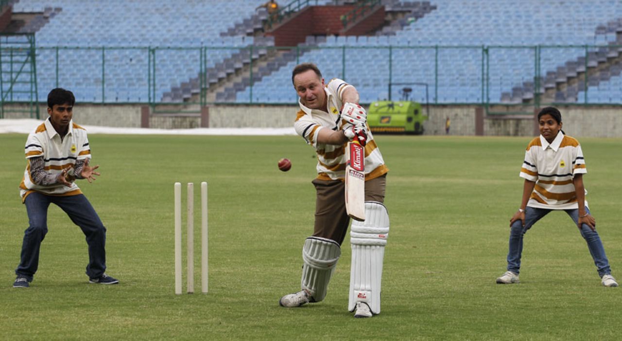 John Key, the New Zealand prime minister, plays cricket with youngsters in India, Delhi, June 27, 2011