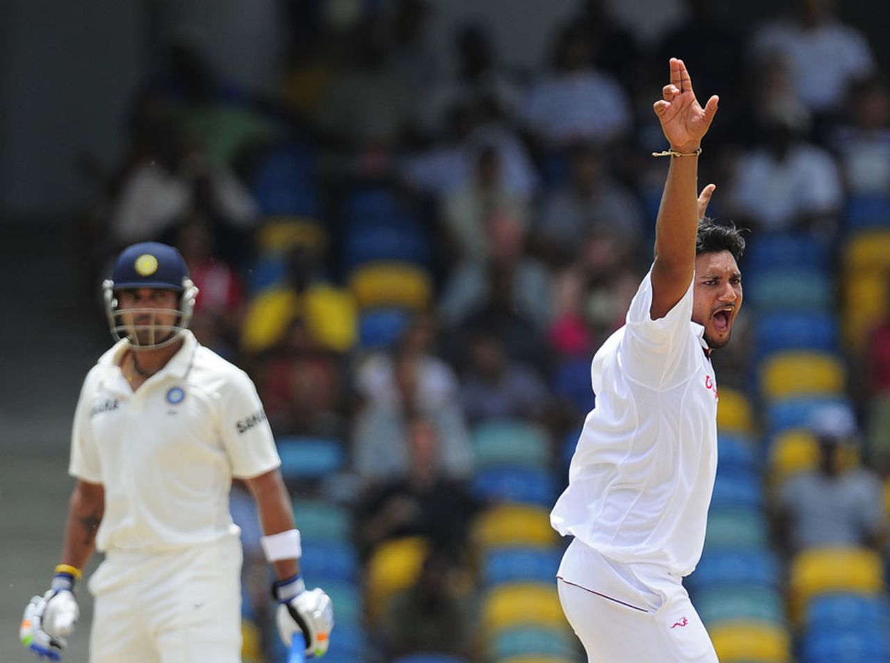 Suresh Raina is hit on the helmet by a Ravi Rampaul bouncer ...