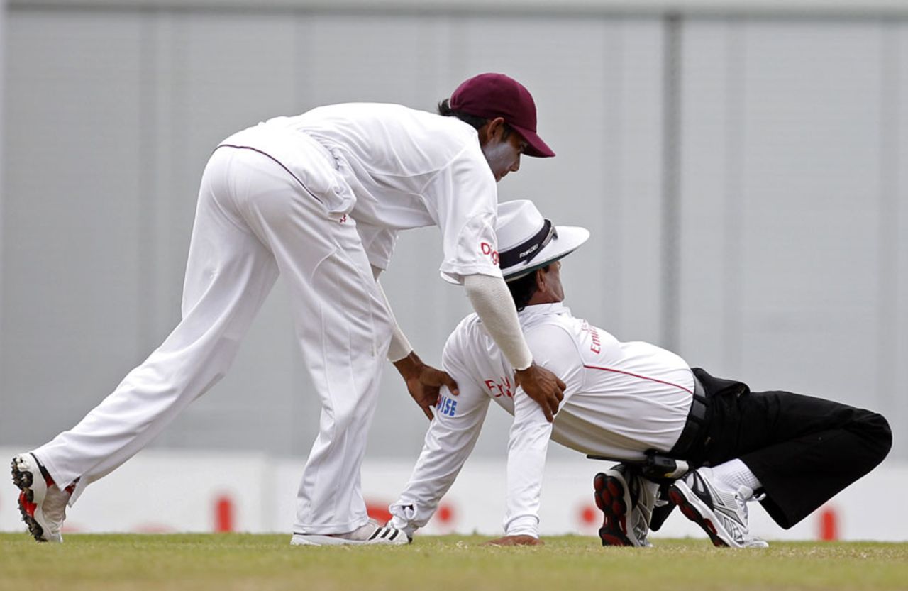 Devendra Bishoo helps Asad Rauf stretch, West Indies v India, 2nd Test, Bridgetown, 4th day, July 1, 2011 