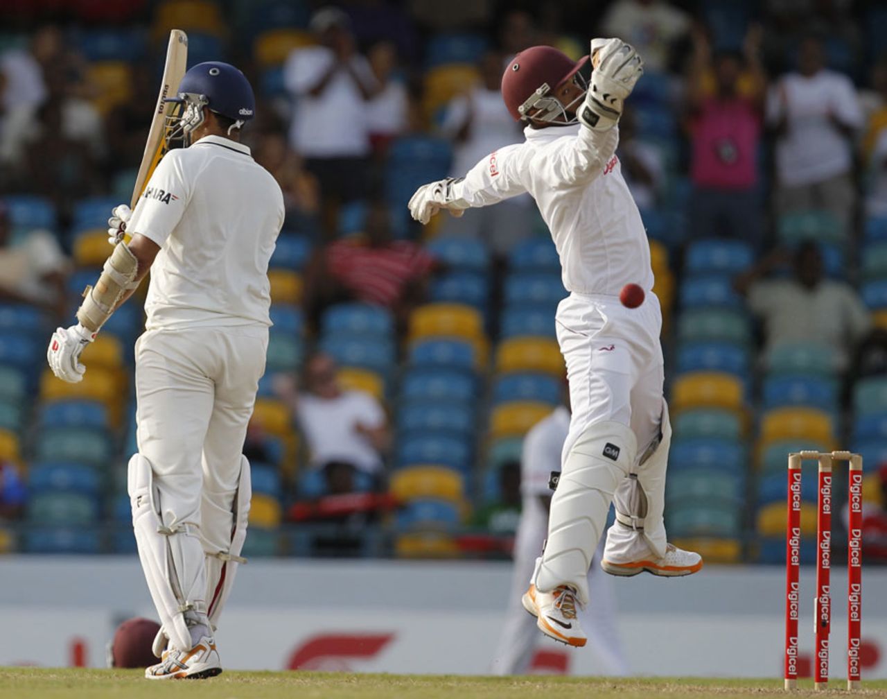 Carlton Baugh leaps to collect a return even as VVS Laxman reacts on reaching his half-century, West Indies v India, 2nd Test, Bridgetown, 4th day, July 1, 2011