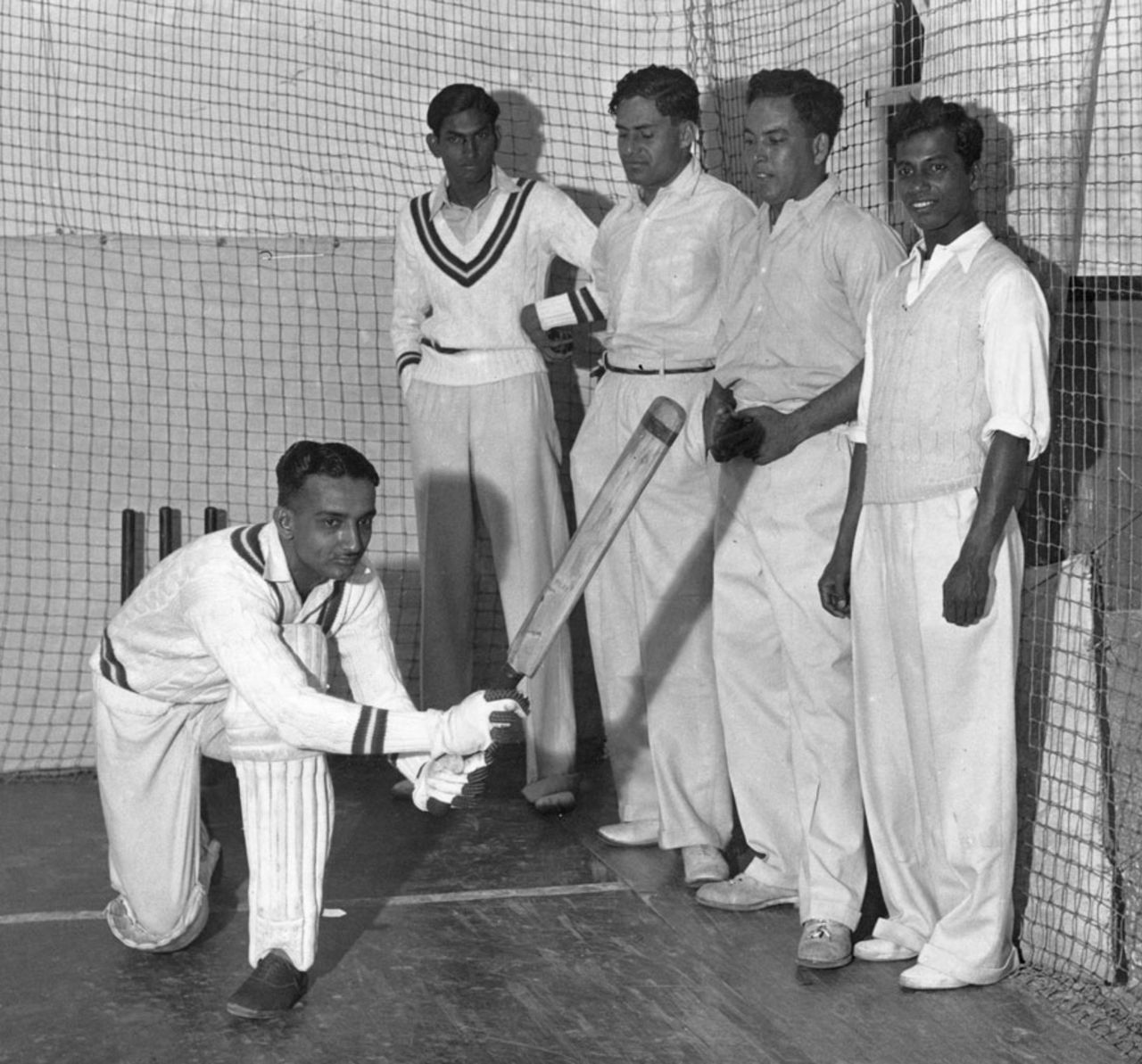 Vijay Merchant bats in the indoor nets of the Alan Fairfax Cricket School as his team-mates look on, London, April 21, 1936