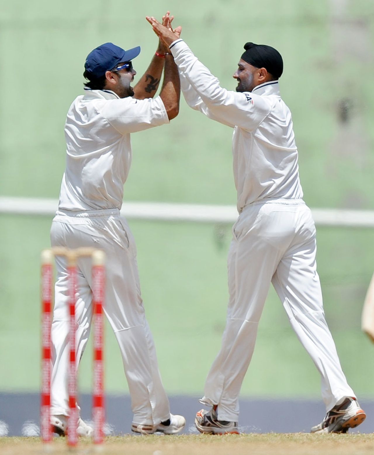 Virat Kohli and Harbhajan Singh celebrate Darren Bravo's wicket, West Indies v India, 3rd Test, Dominica, 4th day, July 9, 2011