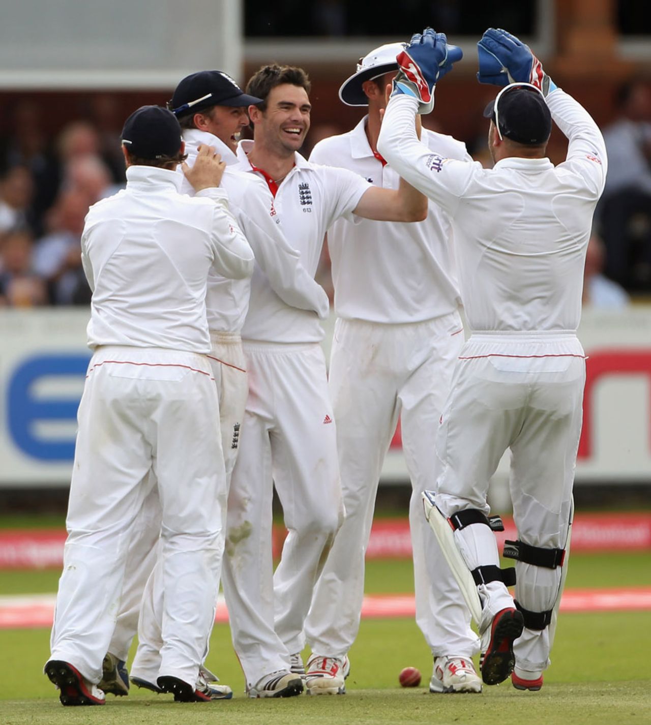 James Anderson is surrounded by team-mates after picking up his fourth wicket, England v India, 1st Test, Lord's, 5th day, July 25, 2011