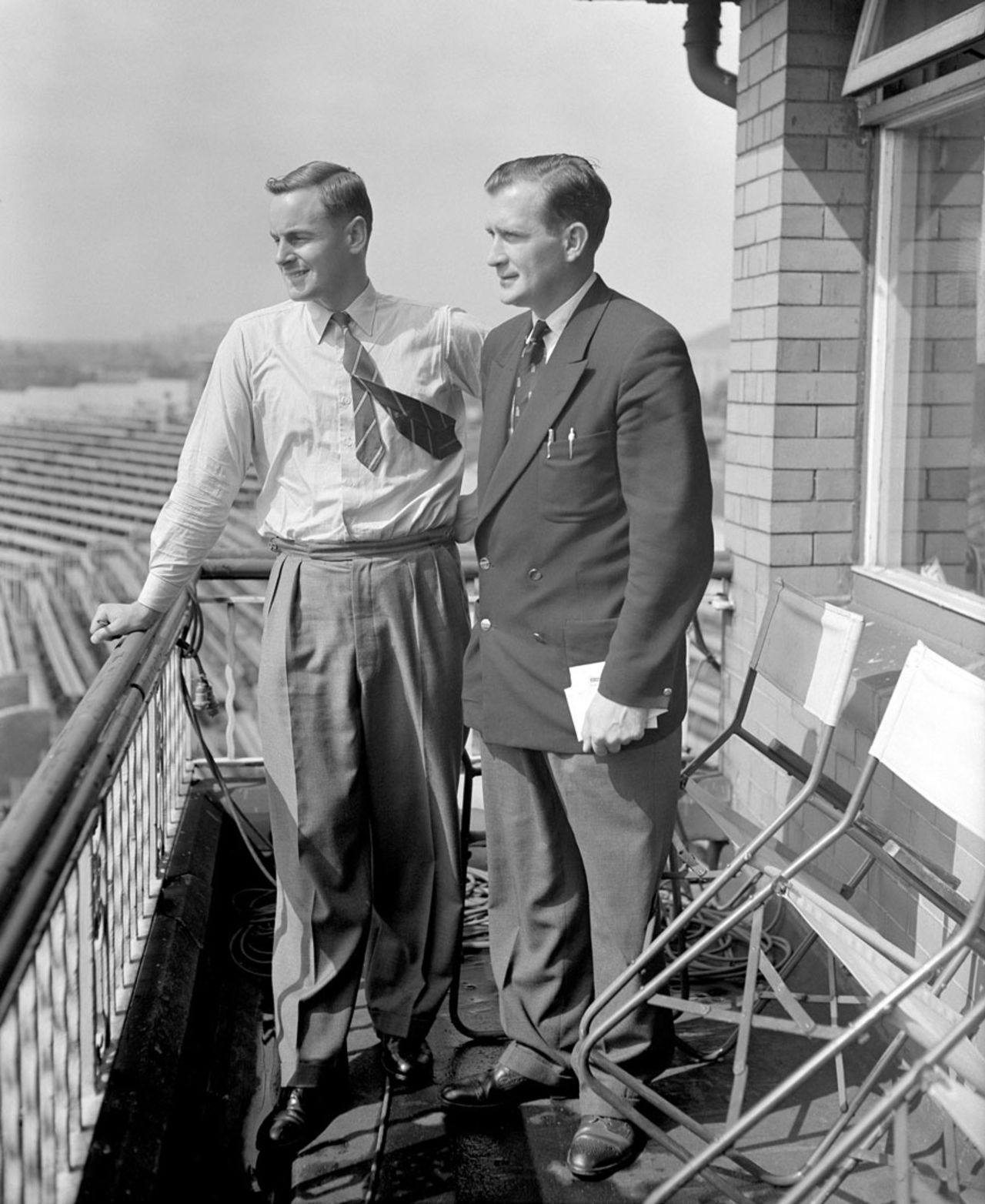Peter May and Jim Laker look out from the players' balcony before the start of the third day, England v Australia, 4th Test, Old Trafford, 3rd day, July 28, 1956