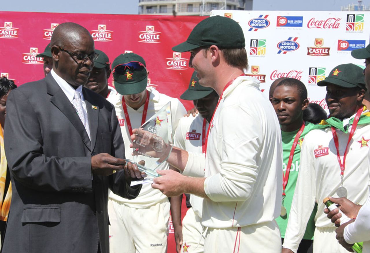 Brendan Taylor receives the winner's trophy from Peter Chingoka, Bangladesh v Zimbabwe, only Test, Harare, 5th day, August 8, 2011