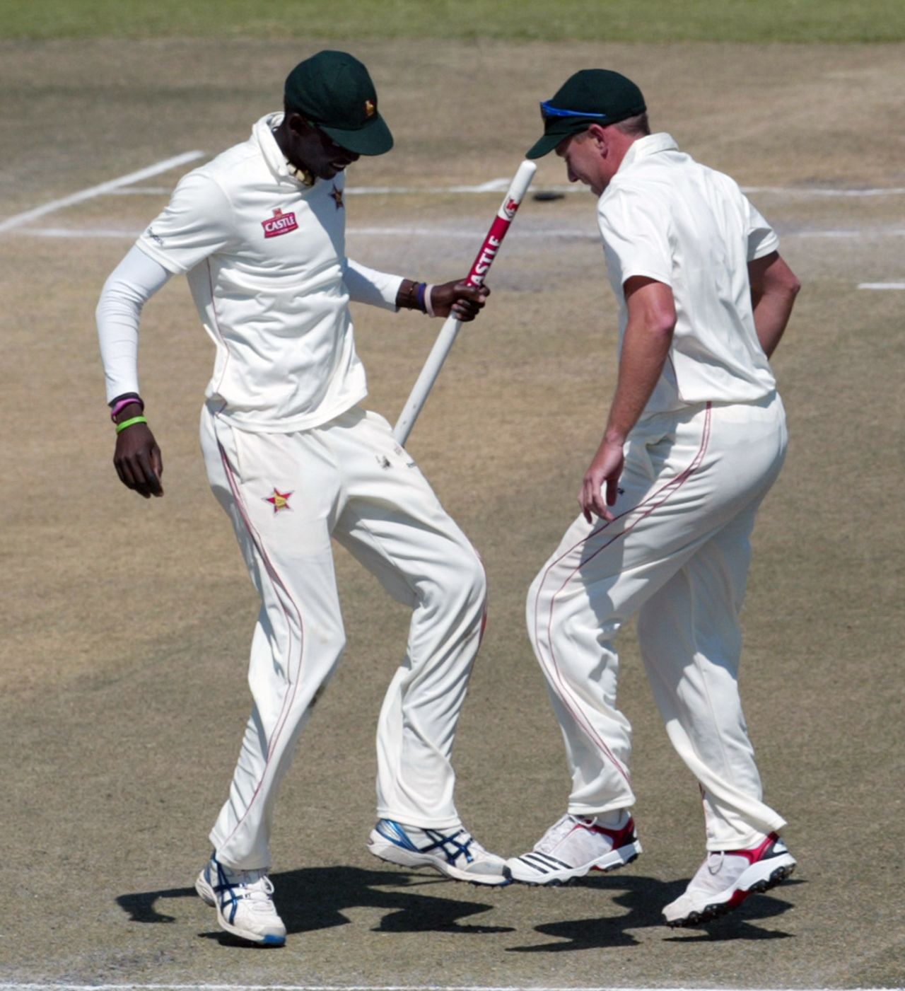 Chris Mpofu and Ray Price do a jig after Zimbabwe win, Bangladesh v Zimbabwe, only Test, Harare, 5th day, August 8, 2011