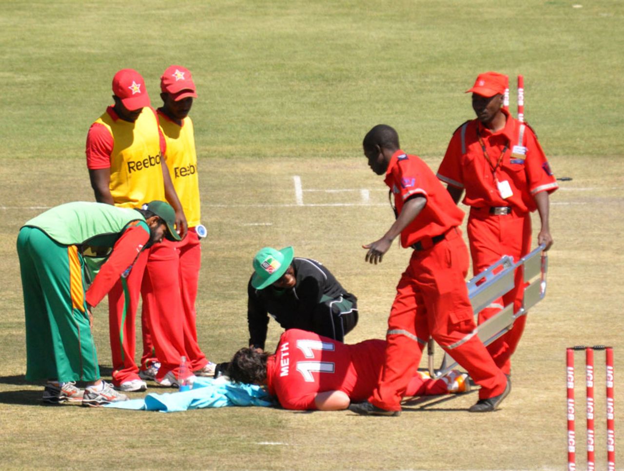 Keegan Meth is attended to after being hit on the face while following through, Zimbabwe v Bangladesh, 5th ODI, Bulawayo, August 21, 2011