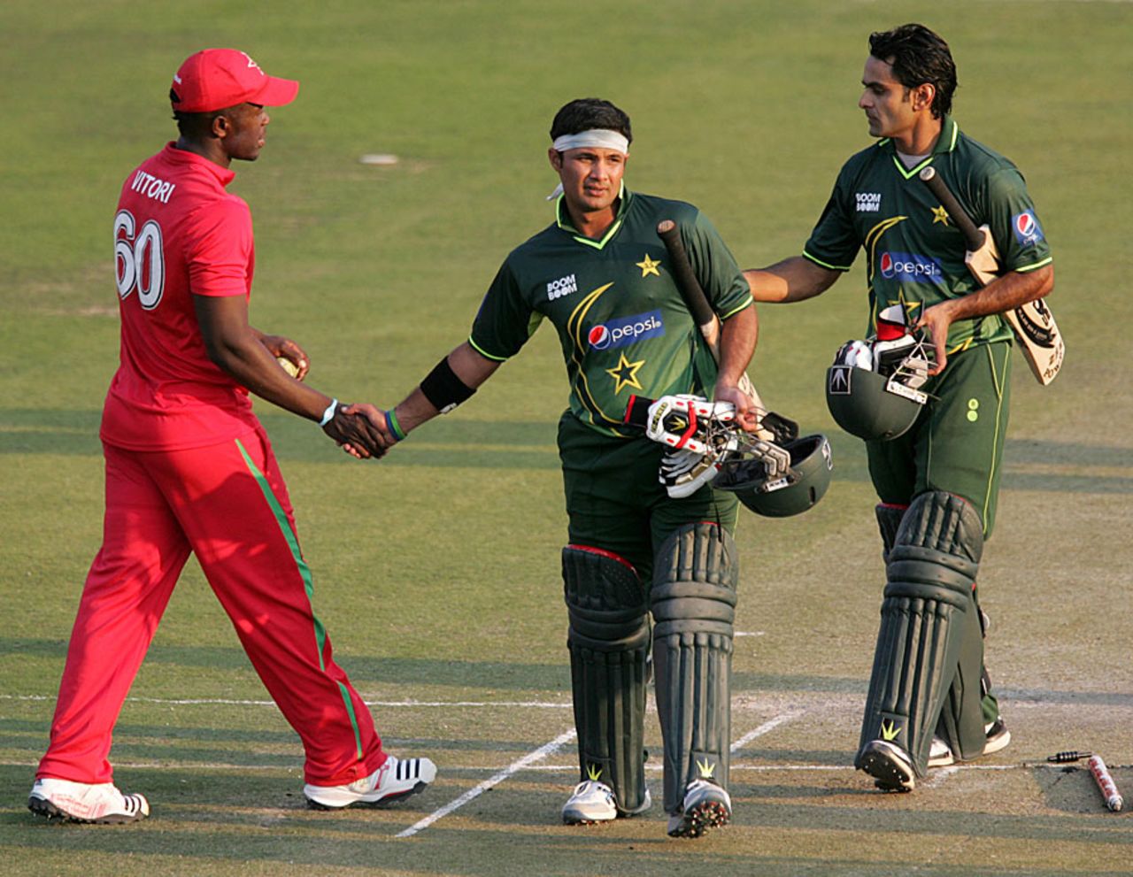 Brian Vitori congratulates Pakistan's openers, Zimbabwe v Pakistan, 2nd ODI, Harare, September 11, 2011 
