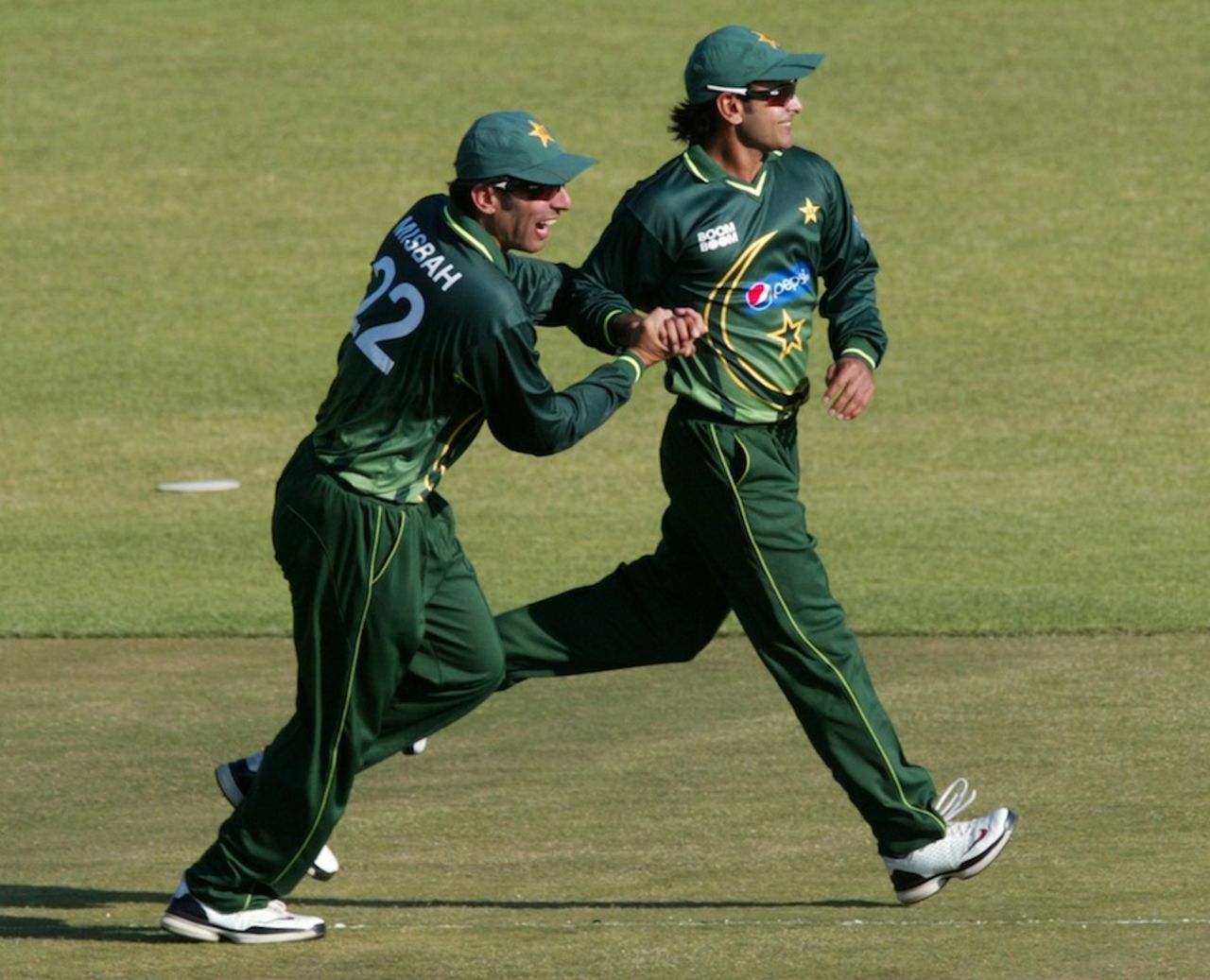 Misbah-ul-Haq and Mohammad Hafeez celebrate a wicket, Zimbabwe v Pakistan, 2nd Twenty20, Harare, September 18, 2011