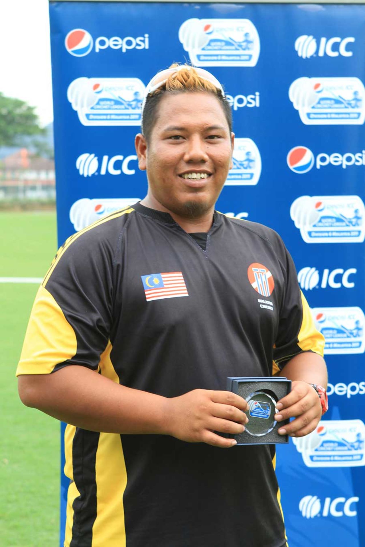 Malaysia's Eszrafiq Aziz with his Man-of-the-Match award after taking 5 for 36, Malaysia v Fiji, World Cricket League Division Six, Kinrara Academy Oval, September 20, 2011