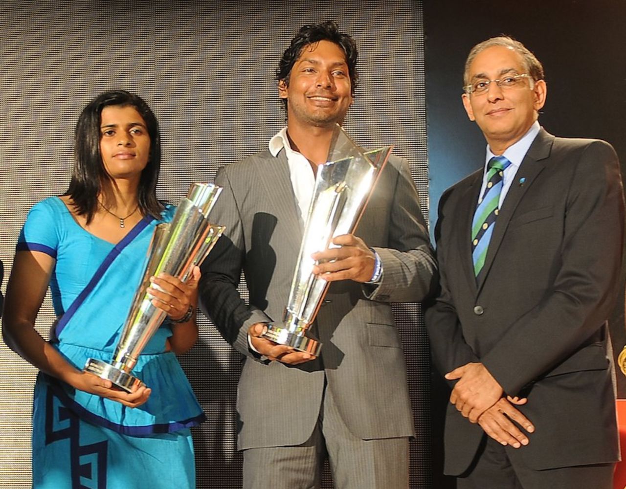Kumar Sangakkara and Shashikala Siriwardene, the Sri Lankan women's captain, with the World Twenty20 trophies, Colombo, September 21, 2011