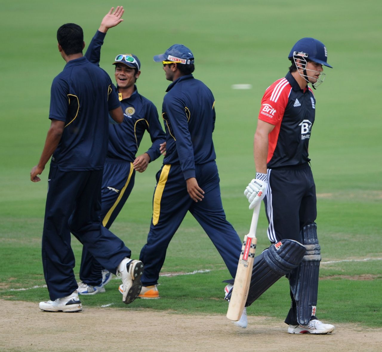 The Hyderabad XI celebrate Alastair Cook's downfall, Hyderabad Cricket Association XI v England XI, Tour Match, Hyderabad, October 8 2011