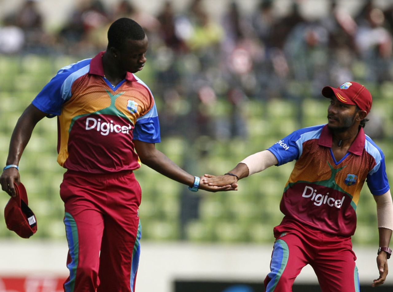 Kemar Roach and Devendra Bishoo get together after a wicket, Bangladesh v West Indies, 2nd ODI, Mirpur, October 15, 2011
