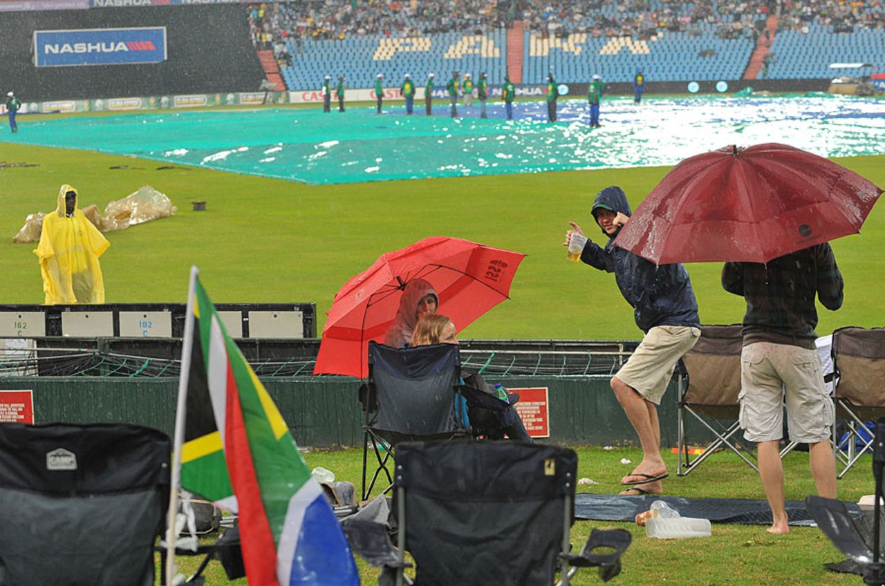 Fans try to stay dry during the heavy rain, South Africa v Australia, 1st ODI, Centurion, October 19, 2011