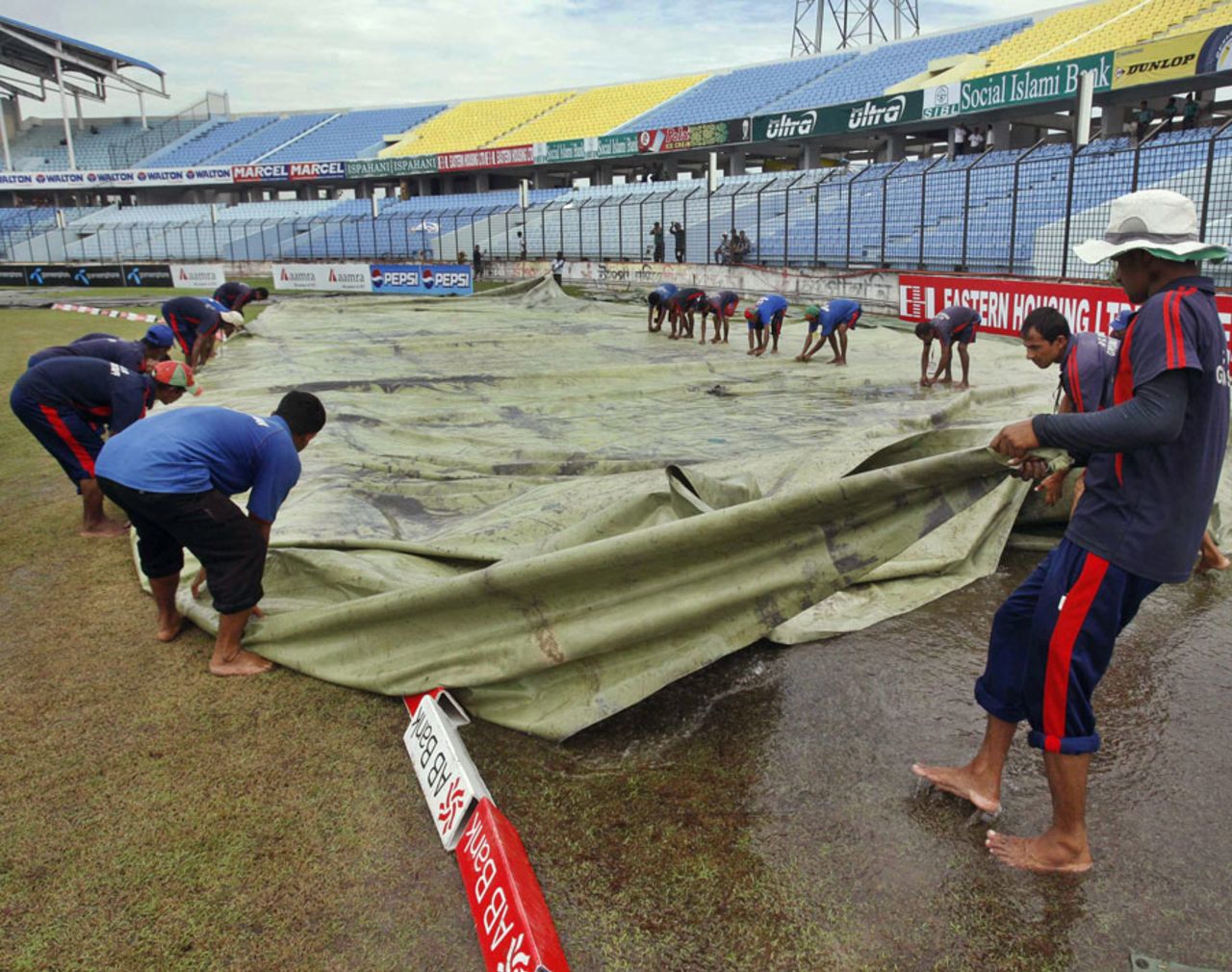 The ground staff pull the covers off, Bangladesh v West Indies, 1st Test, Chittagong, 2nd day, October 22, 2011