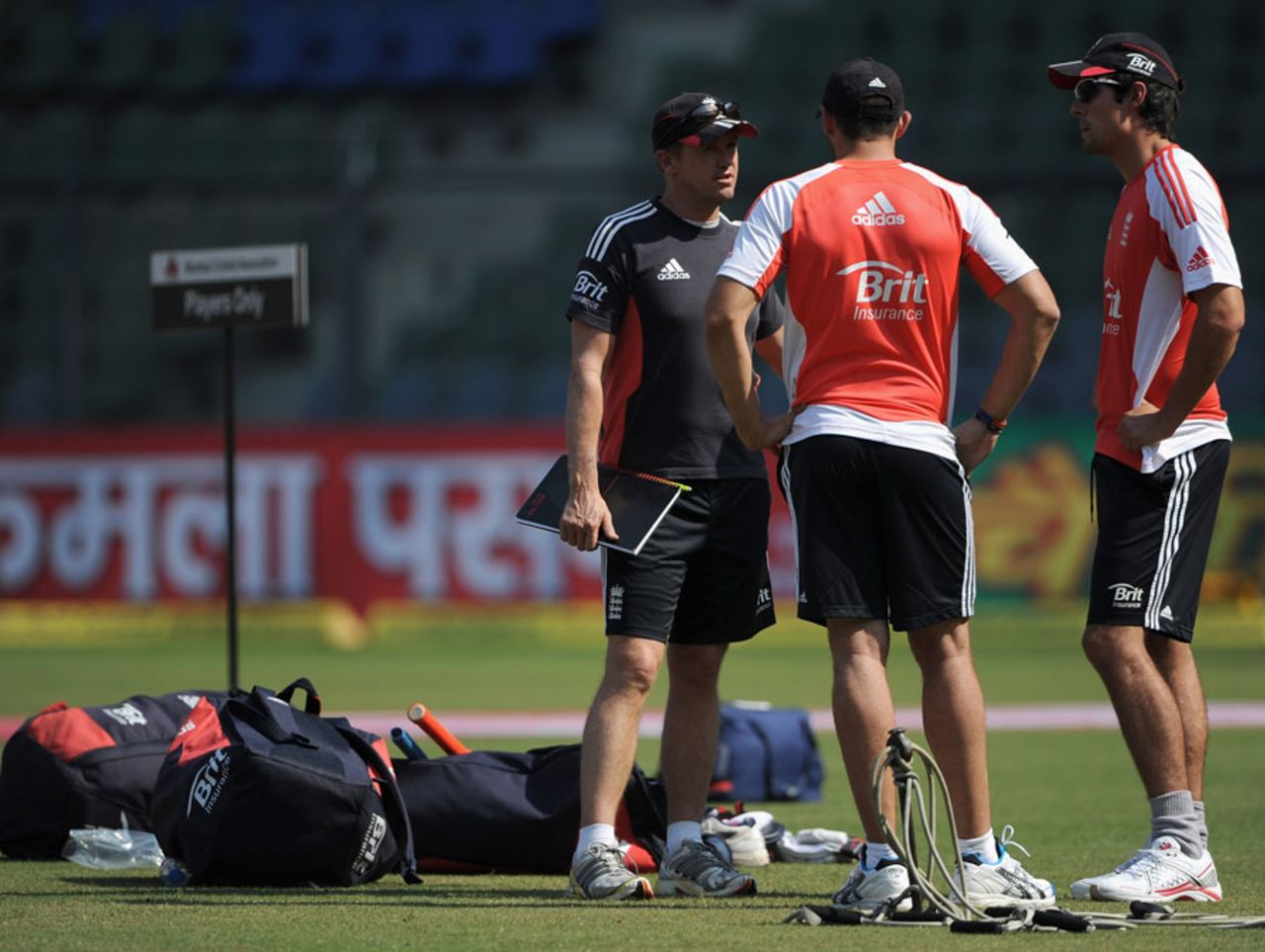 Andy Flower speaks to Tim Bresnan and Alastair Cook during England's nets sessions at the Wankhede Stadium, Mumbai, October 22, 2011