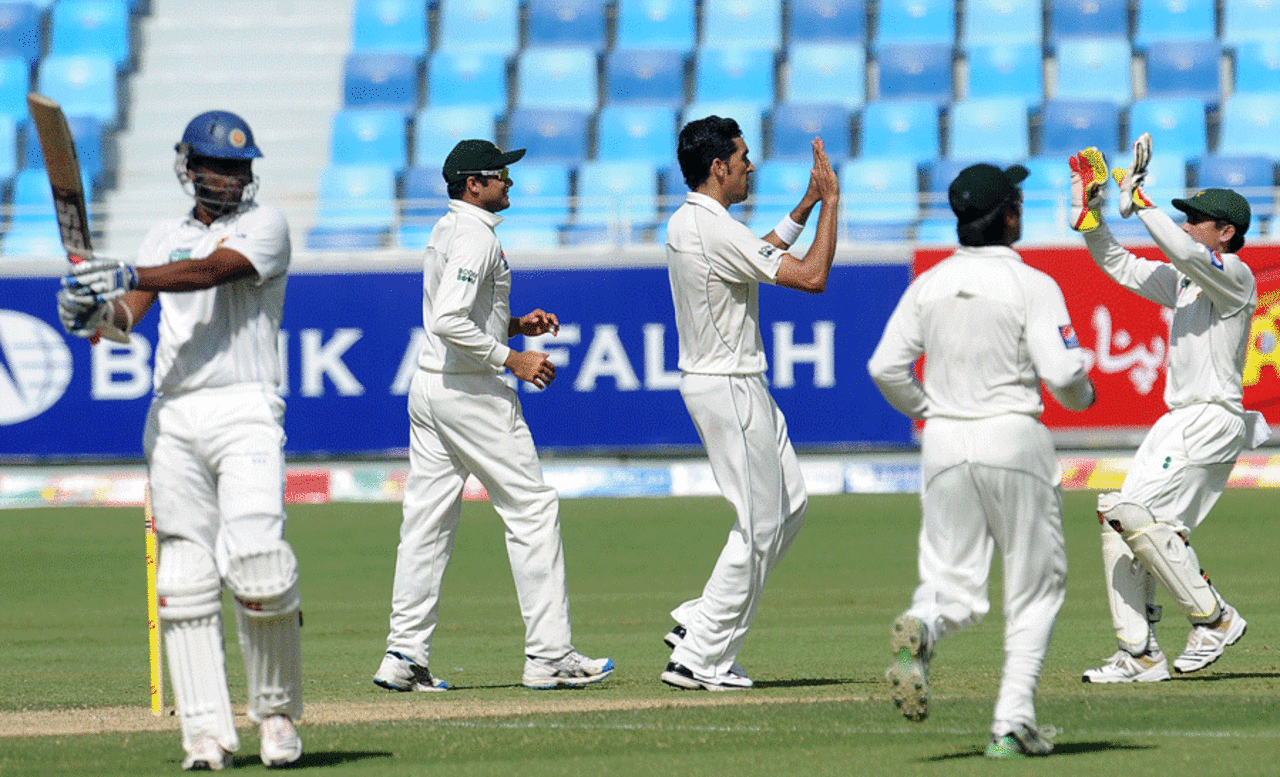 Pakistan celebrate as Tharanga Paranavitana walks off, Pakistan v Sri Lanka, 2nd Test, Dubai, 1st day, October 26, 2011 