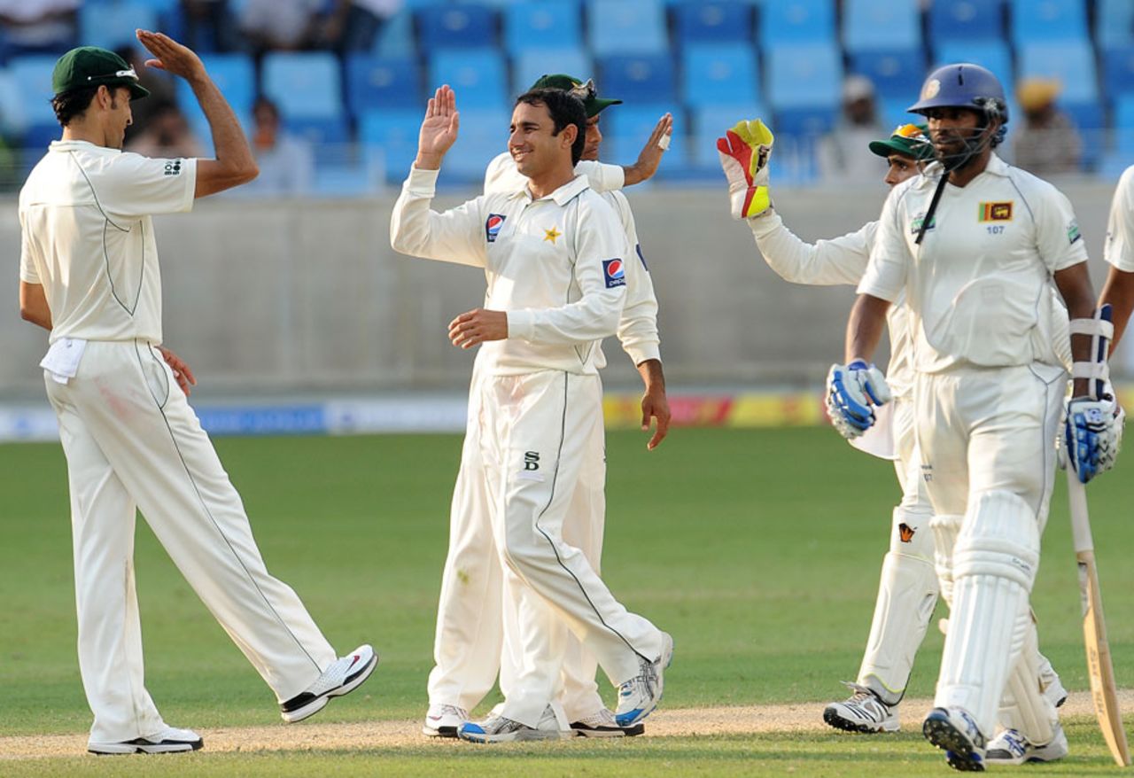Pakistan celebrate after dismissing Chanaka Welegedara and bowling Sri Lanka out for 239, Pakistan v Sri Lanka, 2nd Test, Dubai, 1st day, October 26, 2011 