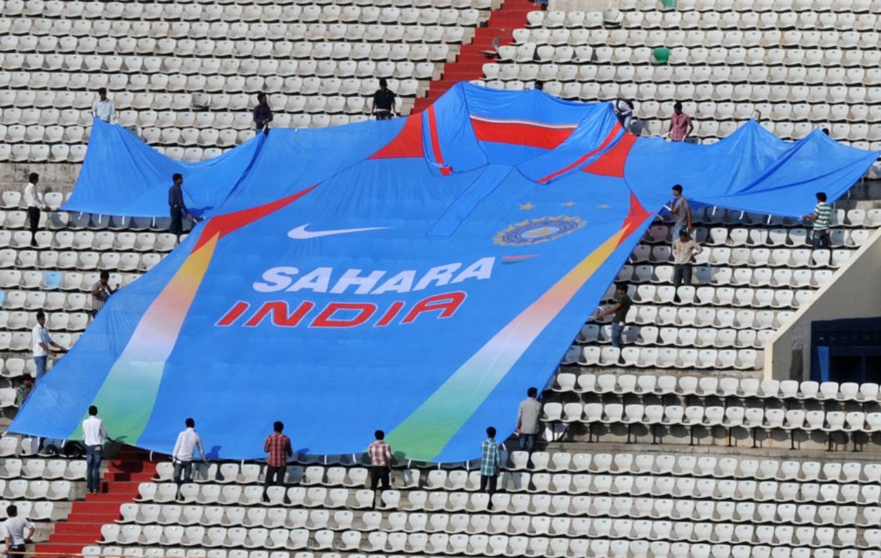 Indian workers arrange a large-scale replica of the Indian one-day jersey, Hyderabad, October 13, 2011