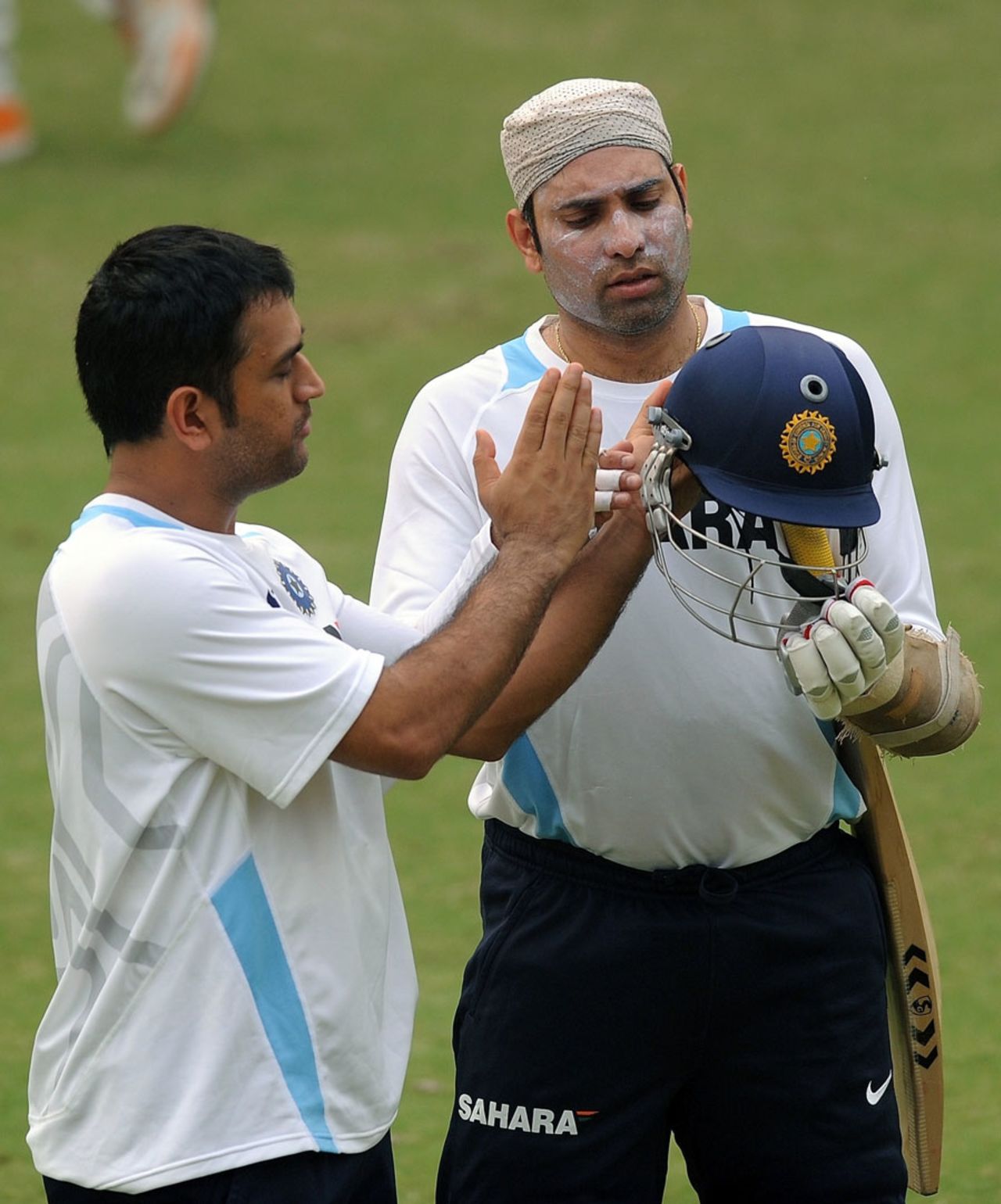 MS Dhoni and VVS Laxman look at the India helmet, Delhi, November 4, 2011