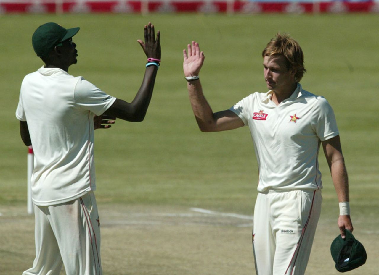 Kyle Jarvis high-fives Chris Mpofu after completing his maiden five-for, Zimbabwe v New Zealand, only Test, Bulawayo, 4th day, November 4, 2011