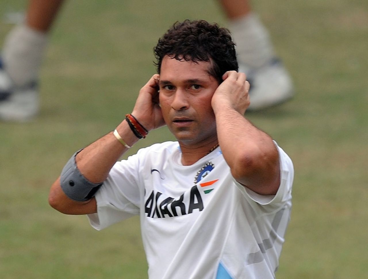 Sachin Tendulkar gestures by covering his ears during practice, Delhi, November 4, 2011