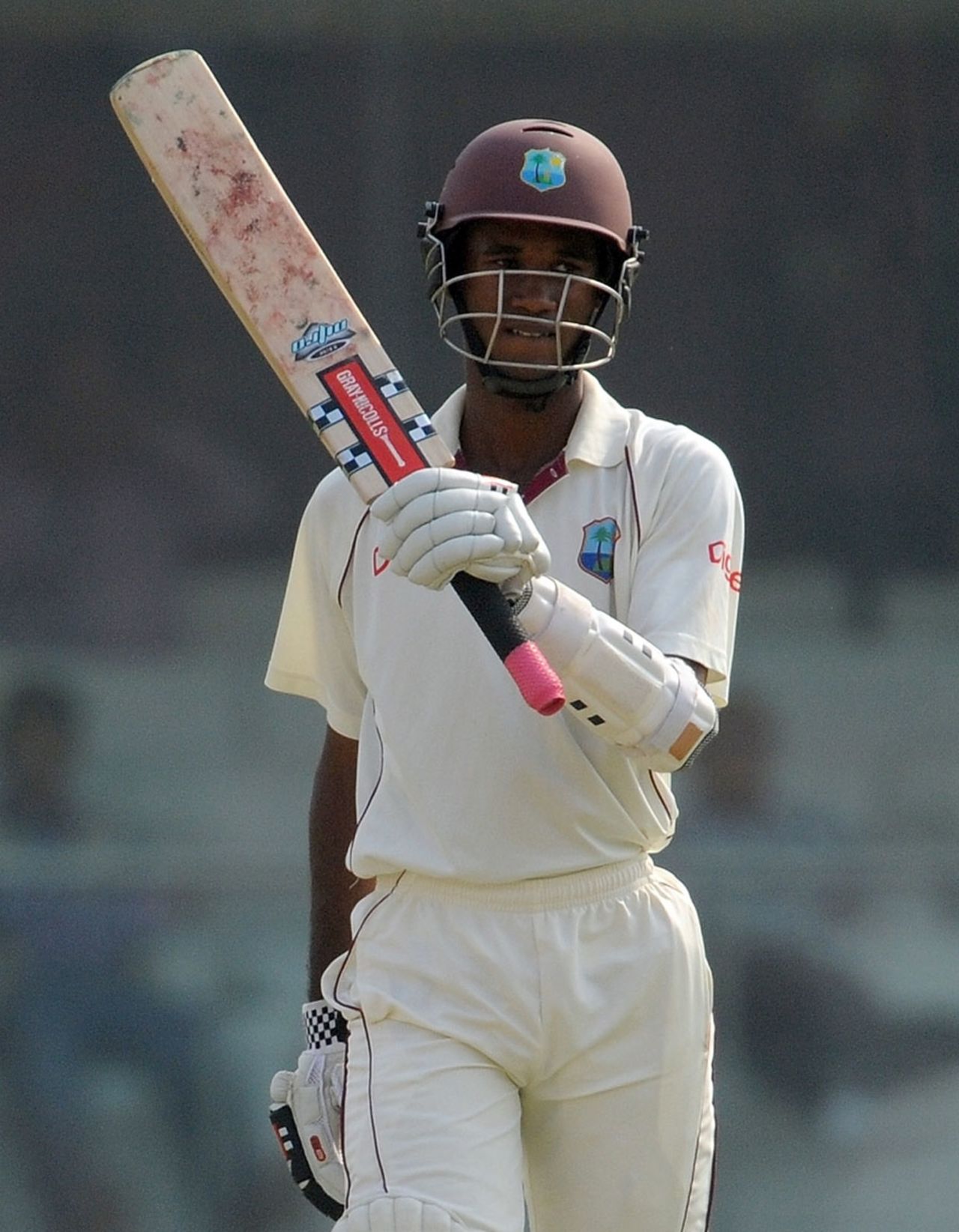 Kraigg Brathwaite raises his bat after reaching his half-century, India v West Indies, 1st Test, New Delhi, 1st day, November 6, 2011
