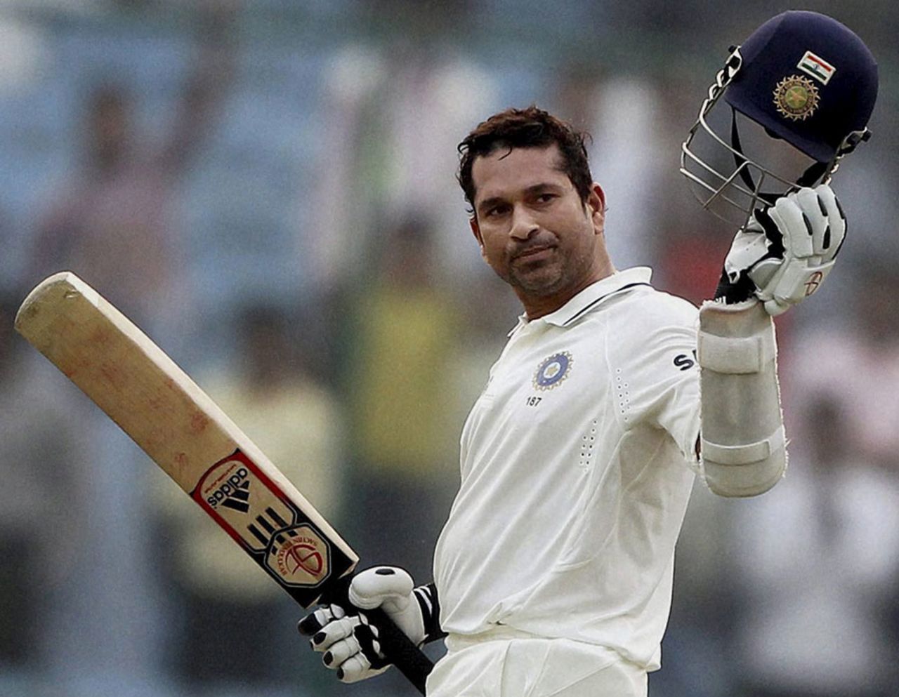 Sachin Tendulkar raises his helmet after reaching 15,000 Test runs, India v West Indies, 1st Test, New Delhi, 3rd day, November 8, 2011