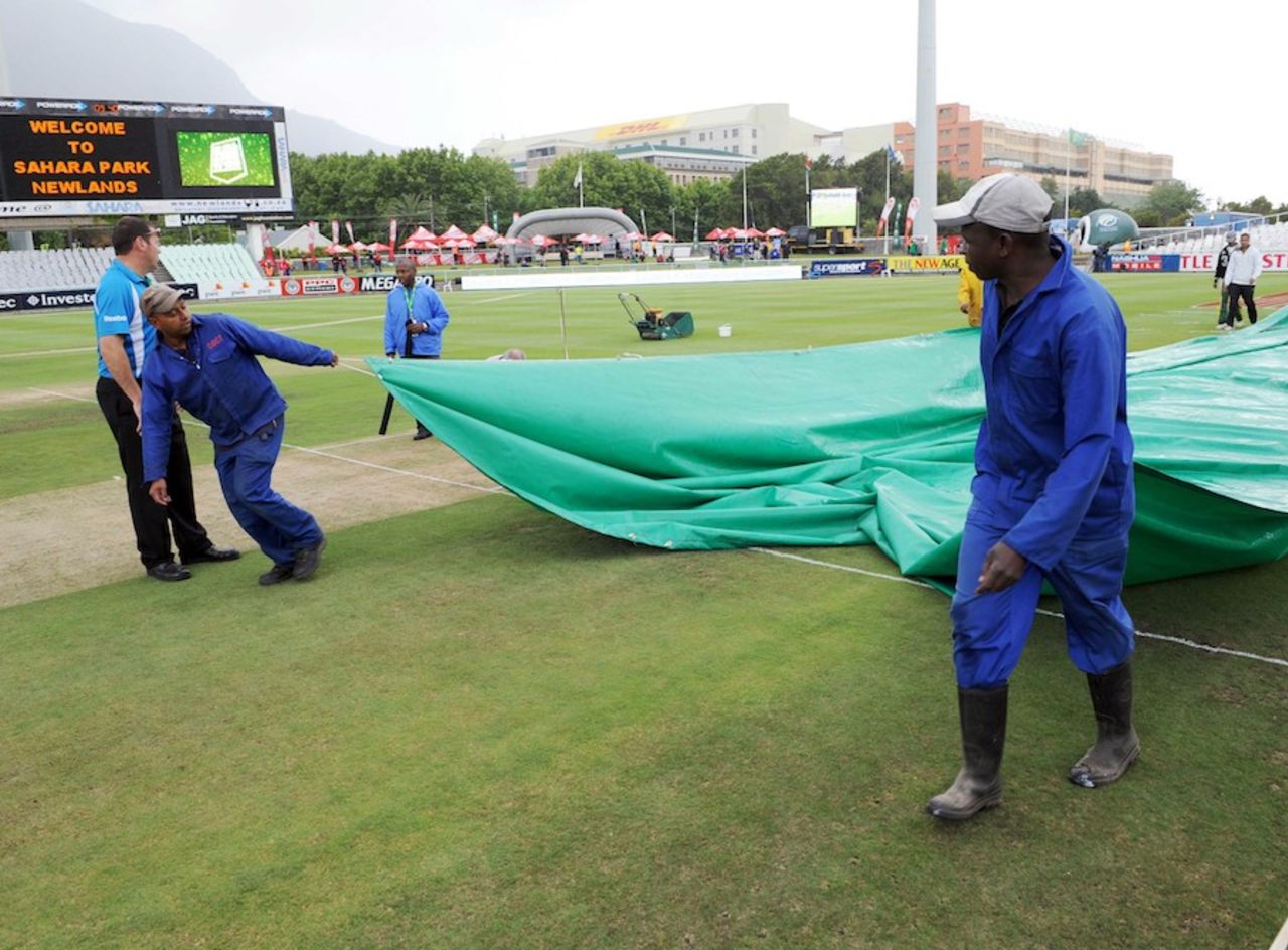 Ground staff cover the pitch at Newlands, South Africa v Australia, 1st Test, Cape Town, 1st day, November 9, 2011