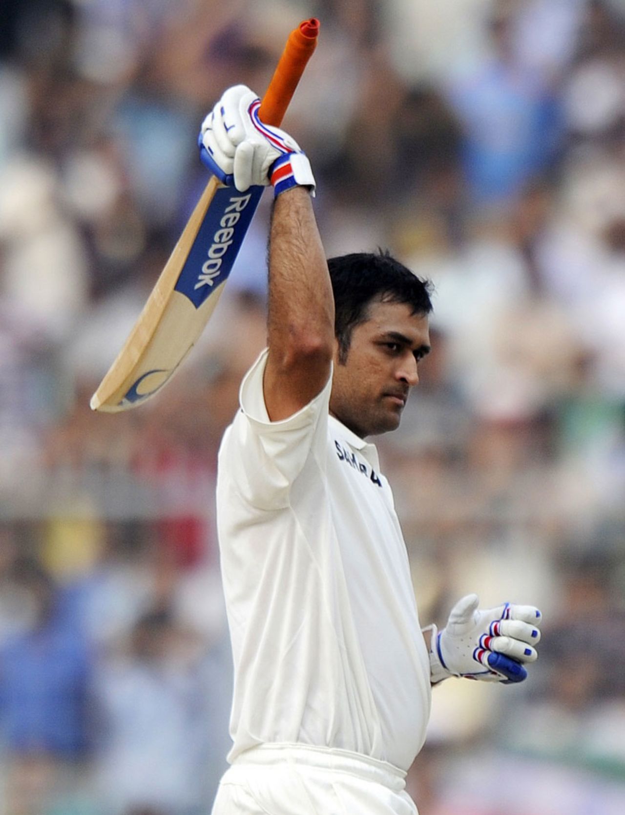 MS Dhoni raises his bat after reaching his century, India v West Indies, 2nd Test, Kolkata, 2nd day, November 15, 2011