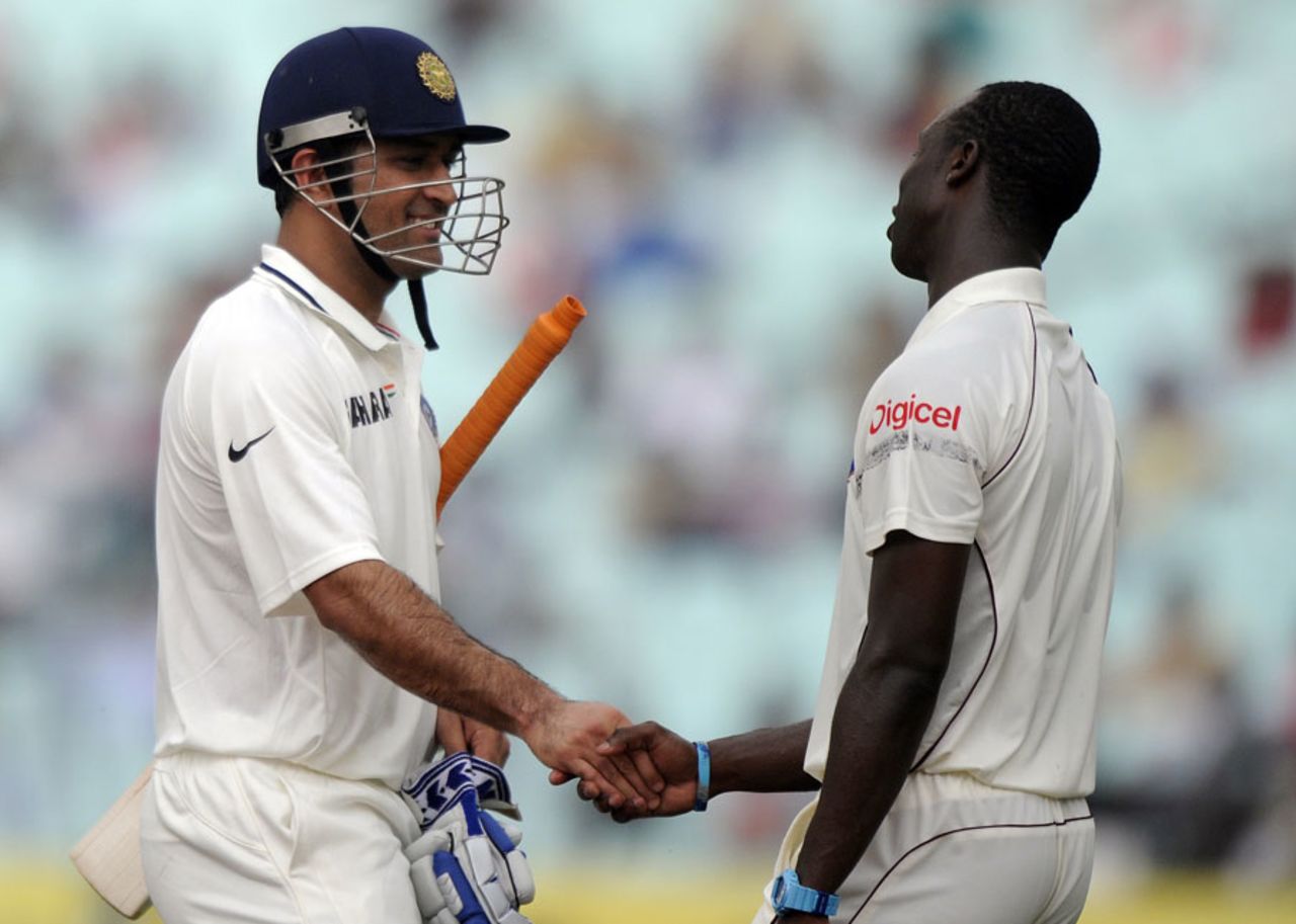 Kemar Roach congratulates MS Dhoni on his hundred, India v West Indies, 2nd Test, Kolkata, 2nd day, November 15, 2011
