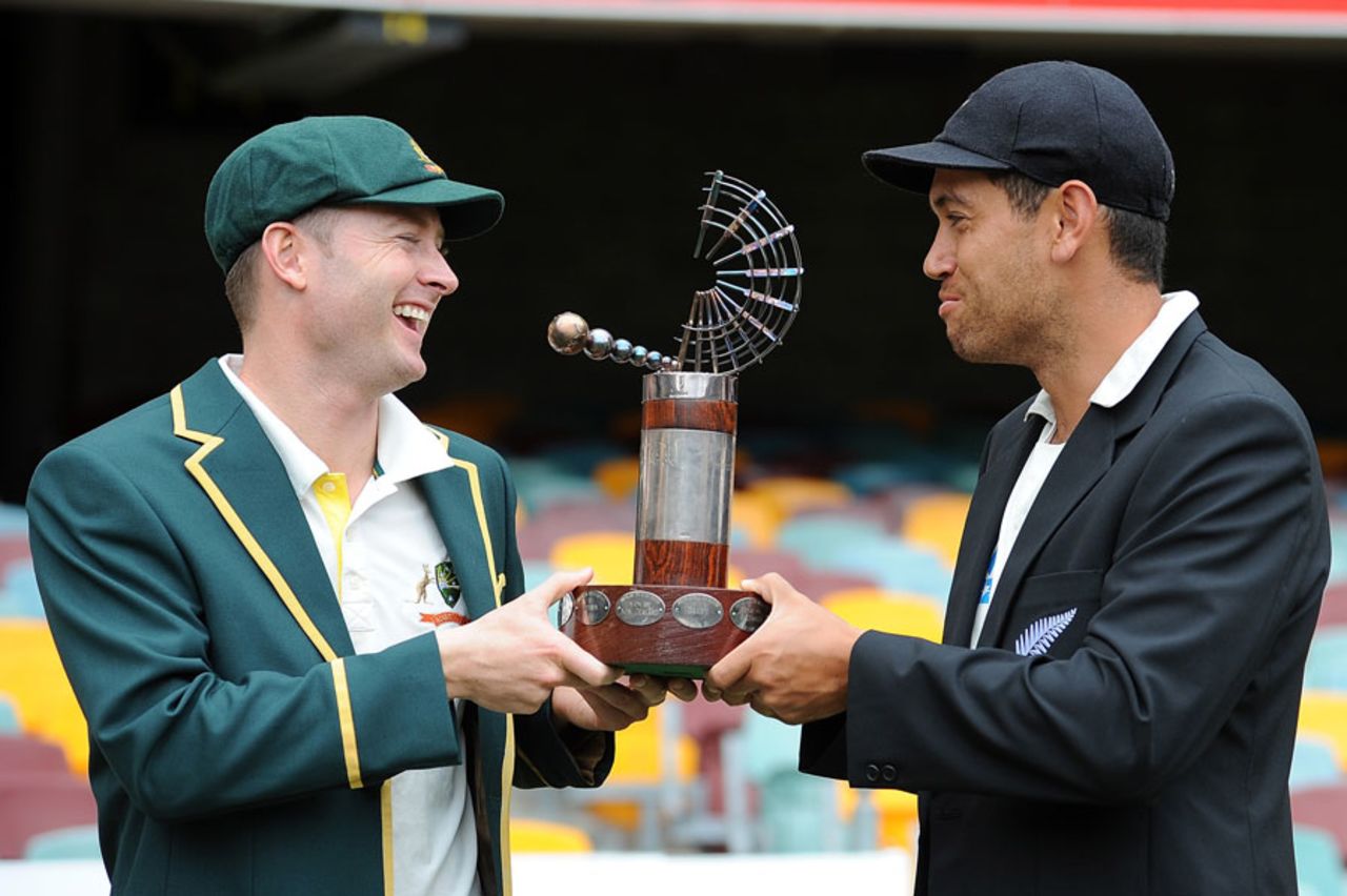 Michael Clarke and Ross Taylor laugh while posing with the Trans-Tasman Trophy, Brisbane, November 30, 2011