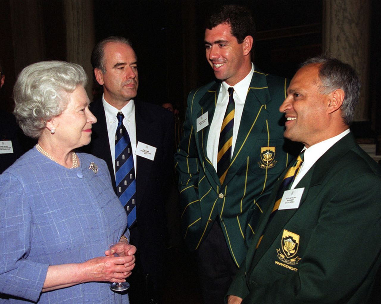 Queen Elizabeth talks to South Africa team manager Goolam Rajah, accompanied by Hansie Cronje and Tim Lamb at Buckingham Palace, London, June 2, 1999