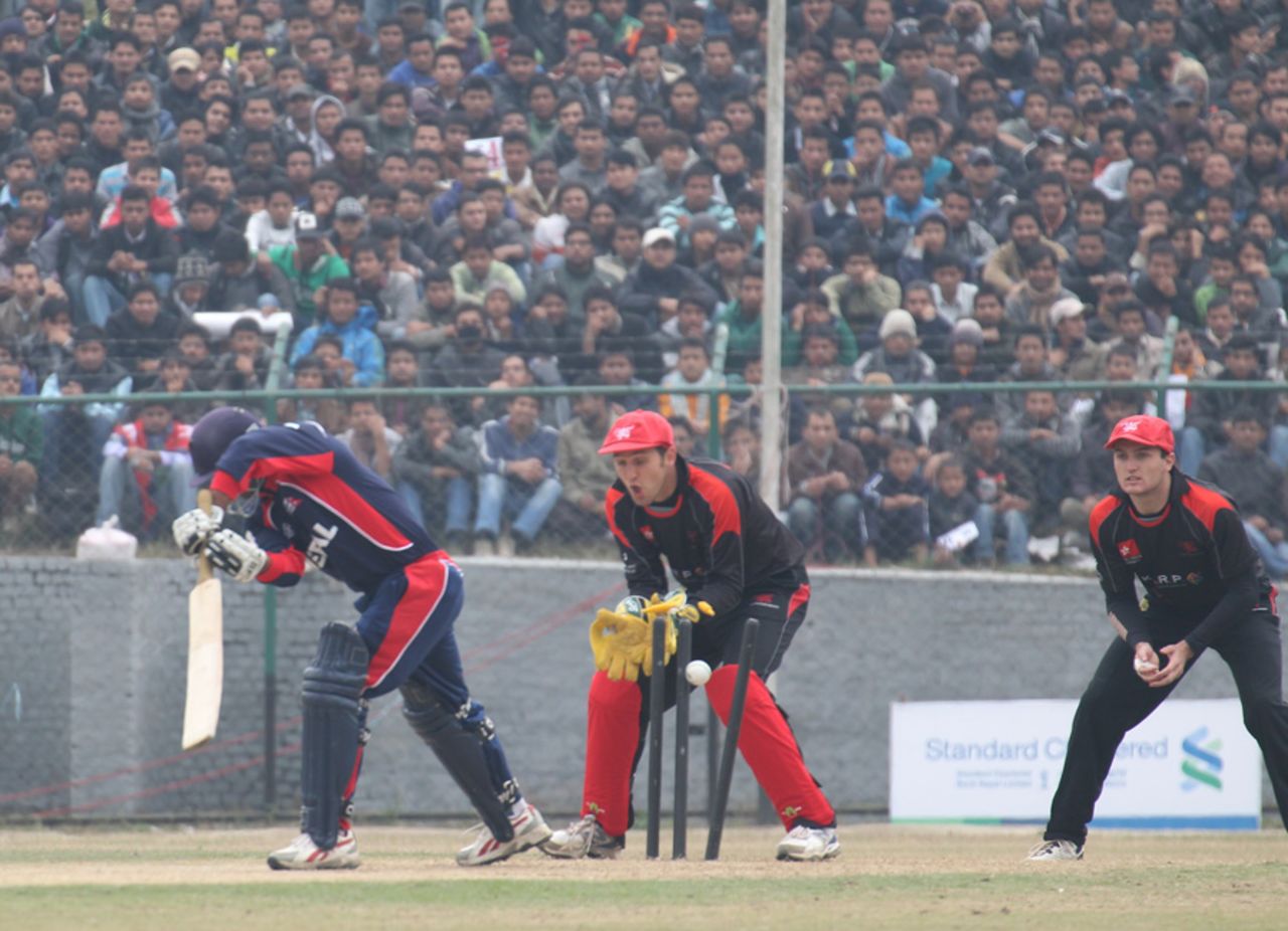 Nepal's Anil Mandal is bowled by Moner Ahmed during the ACC Twenty20 Cup 2011 match in front of a big crowd at Tribhuvan University Ground in Kathmandu on 3rd December 2011