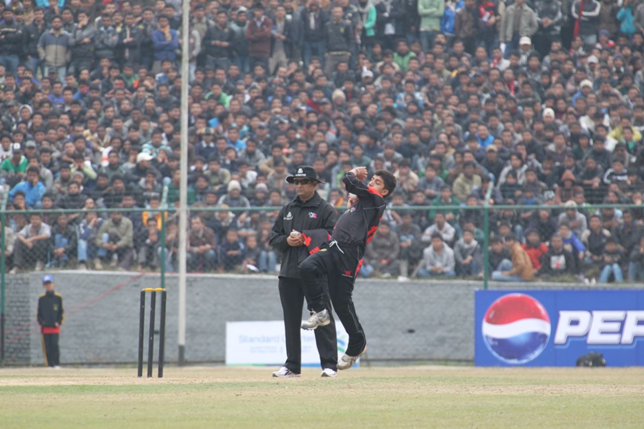 A capacity crowd looks on as Aizaz Khan bowls during the ACC Twenty20 Cup 2011 match against Nepal at the Tribhuvan University Ground in Kathmandu on 3rd December 2011