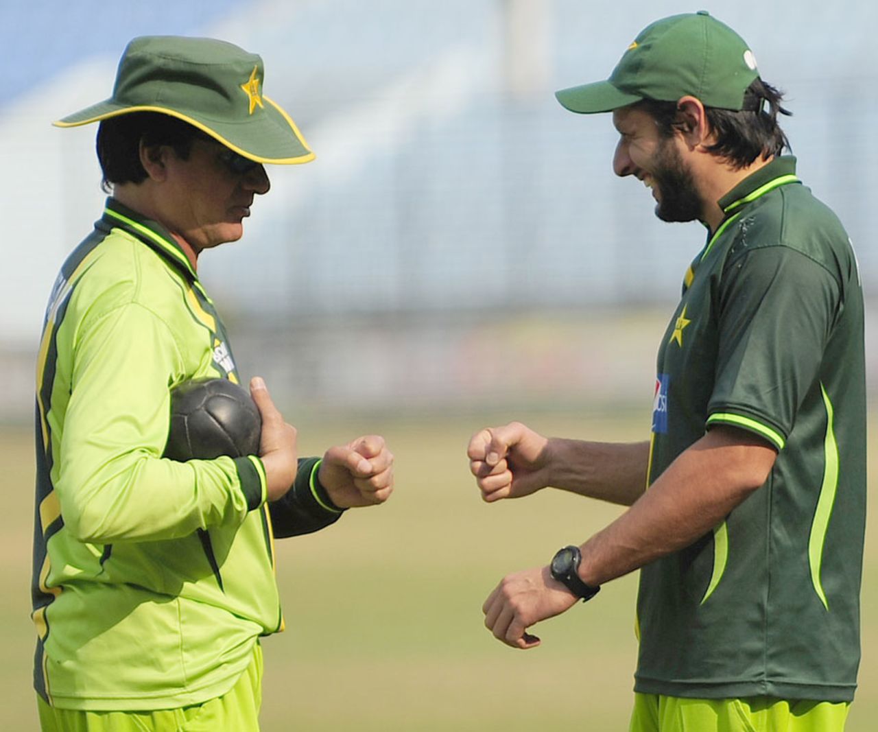 Mohsin Khan and Shahid Afridi share a light moment in training, Chittagong, December 5, 2011