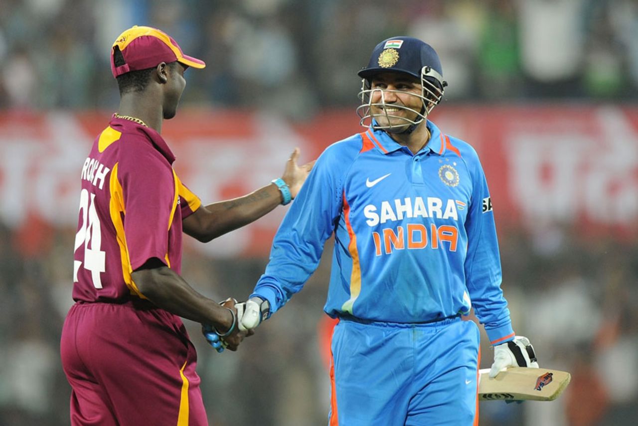Virender Sehwag is congratulated by Kemar Roach while walking off, India v West Indies, 4th ODI, Indore, December 8, 2011