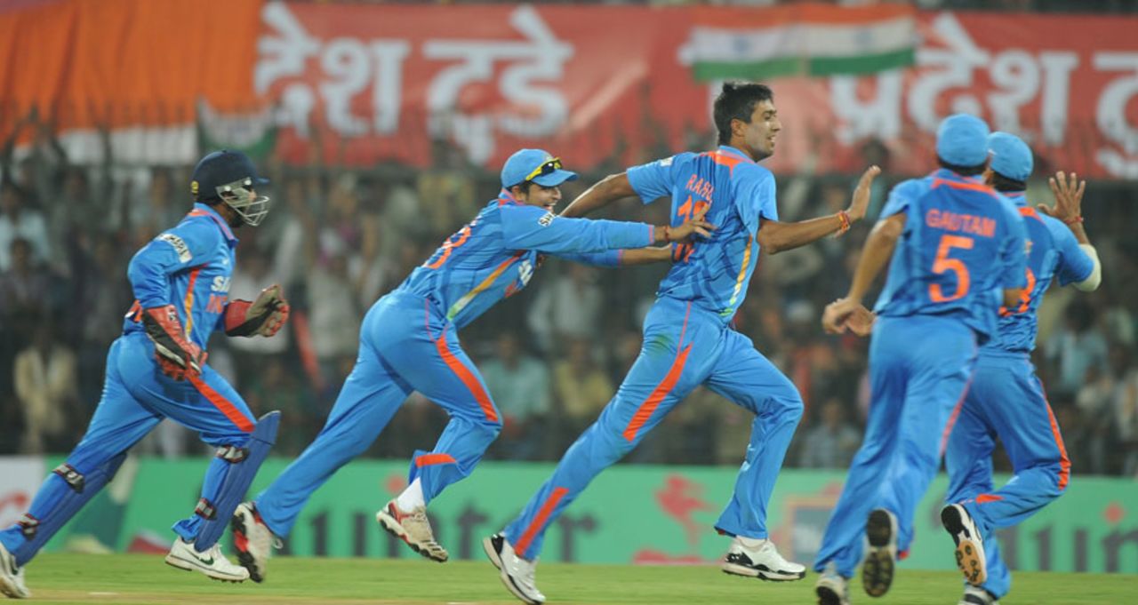 Rahul Sharma is mobbed by his team-mates after taking a wicket, India v West Indies, 4th ODI, Indore, December 8, 2011