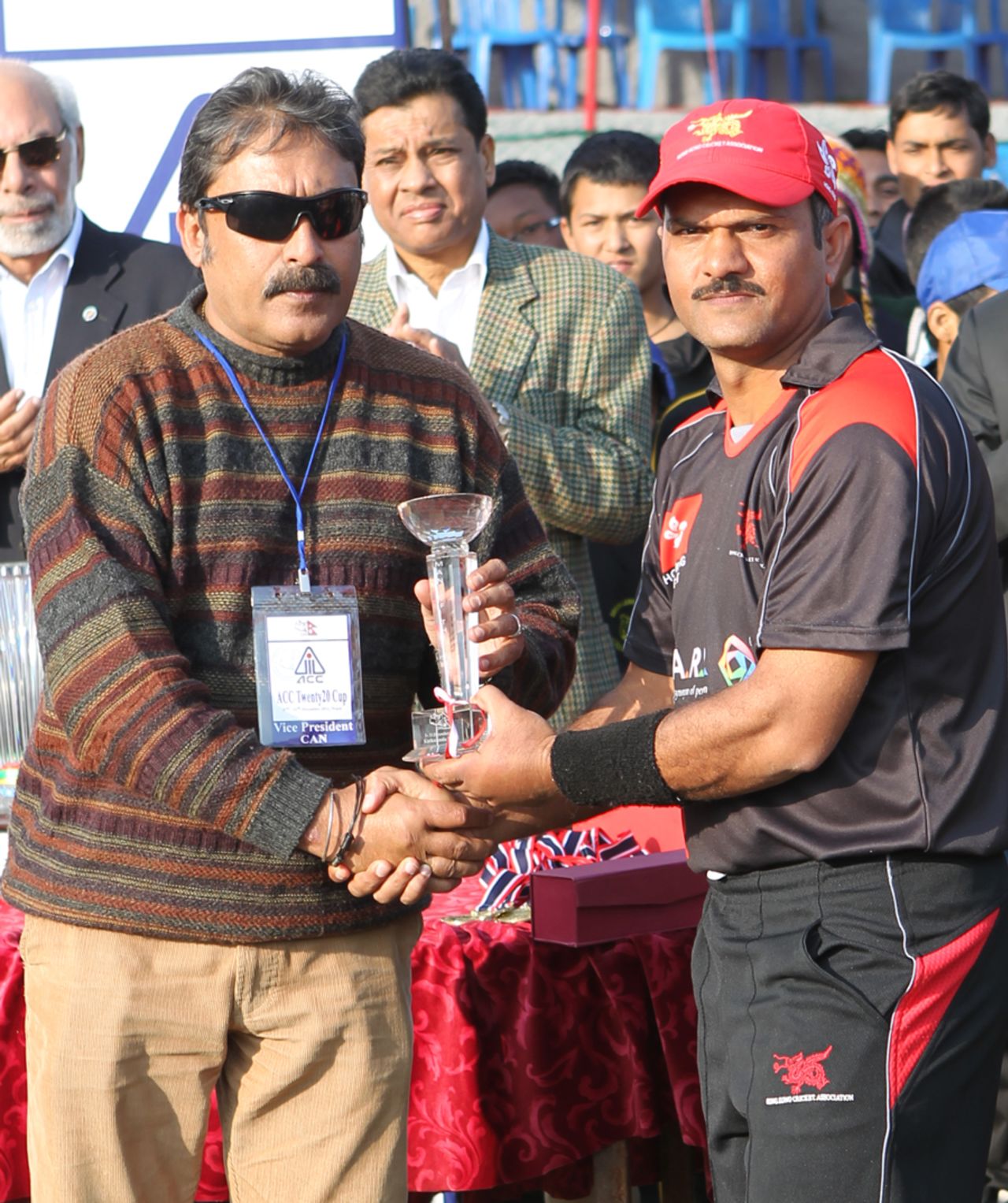 Hong Kong's Moner Ahmed receives the Player of the Series trophy from CAN Vice President Mr Shriniwas Rana at the ACC Twenty20 Cup 2011 in Kathmandu